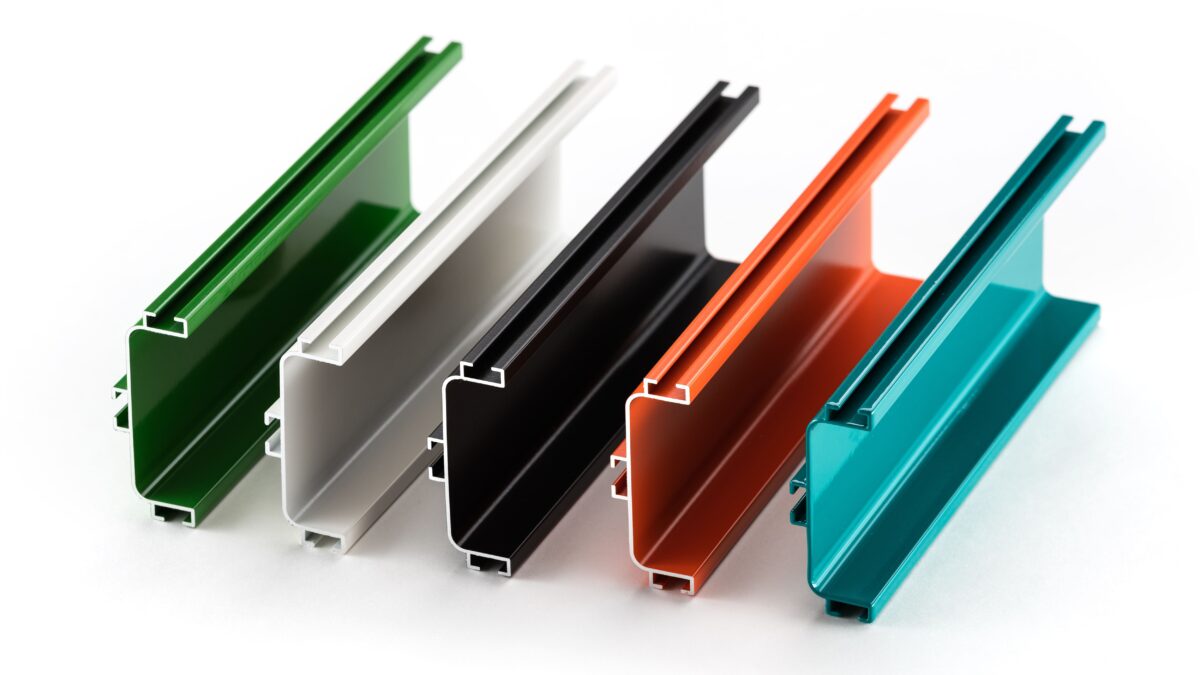 A selection of anodized aluminium profiles in various anodizing aluminium colors, including green, white, black, orange, and teal, showcasing surface finishing options.